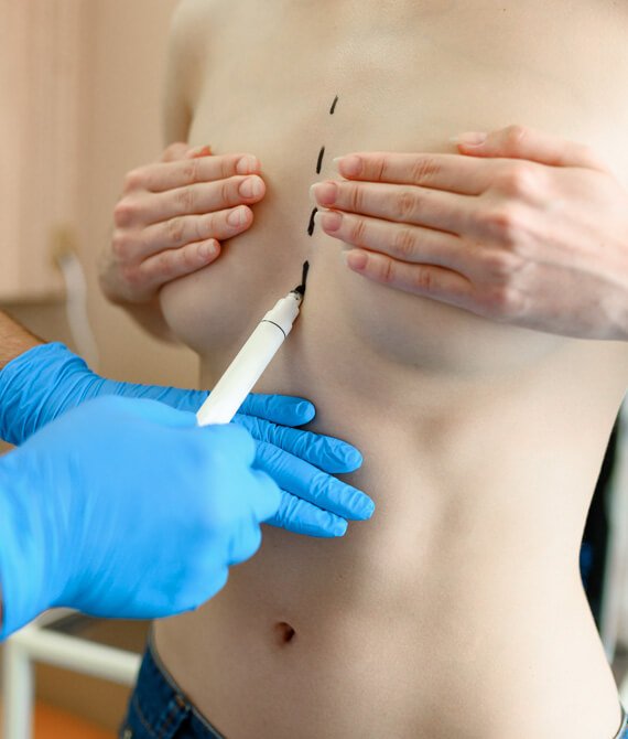male surgeon prepares woman for surgery in clinic KGEENNV